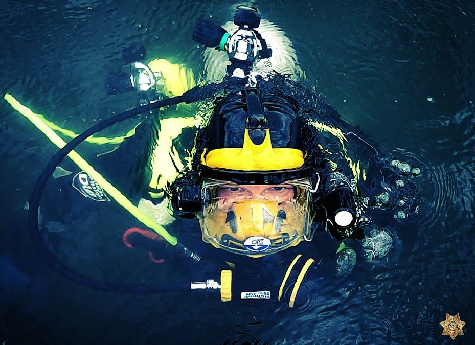 Story County Sheriff's Office Rescue Diver coming up from under the water.
