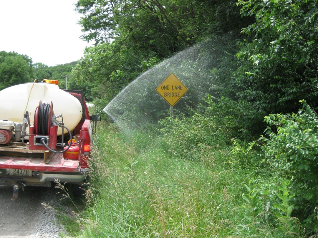 Truck spraying right of way along roadside