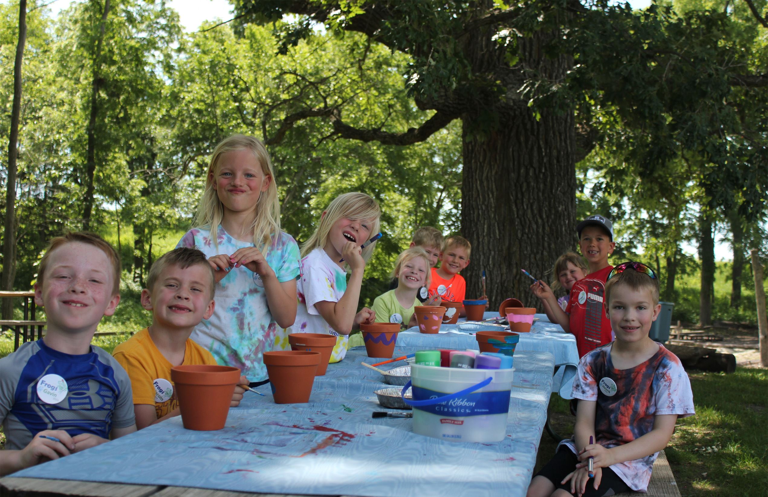Nature campers paint craft outdoors