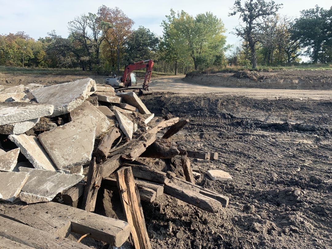 Concrete chunks and broken skids form pile inside drained McFarland Lake creating fish structure