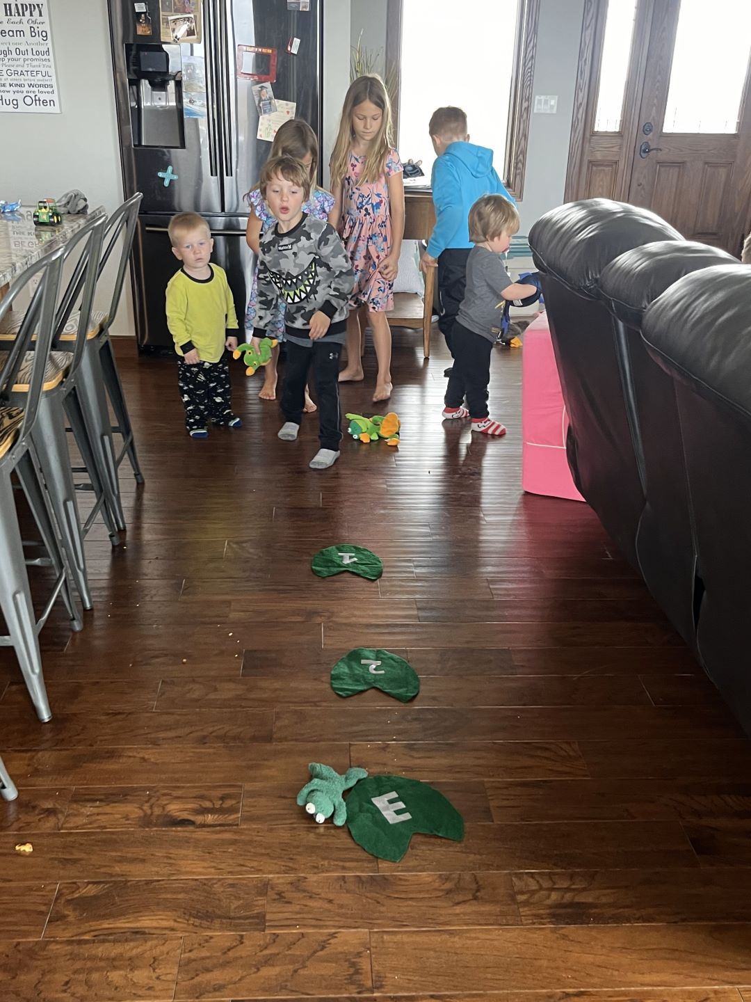 Boy tosses stuffed frog during educational activity for Nature Box