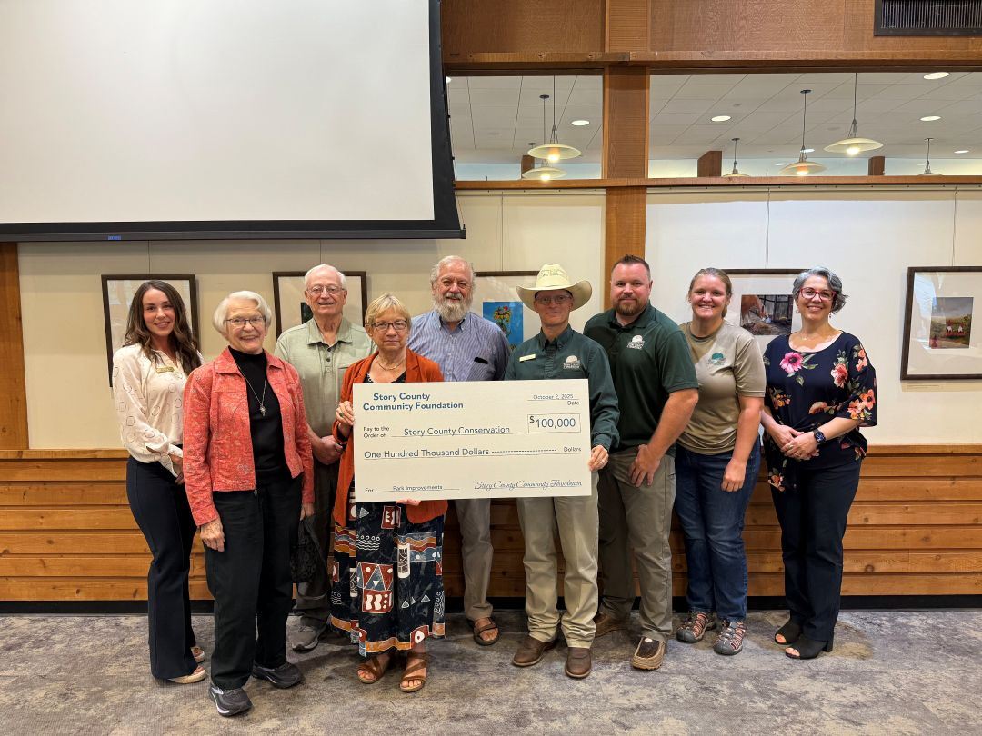 Story County Conservation employees pose with giant check written for $100,000